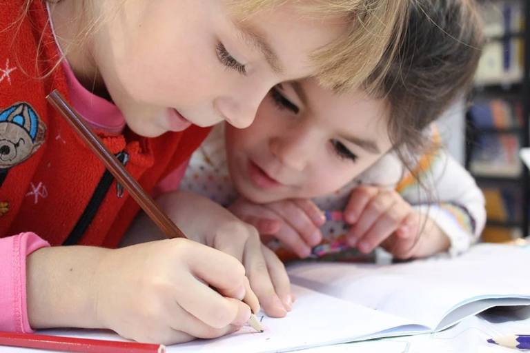 children writing in school book