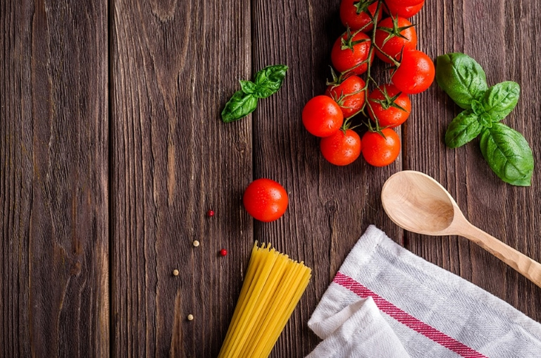 spaghetti and tomatoes on table
